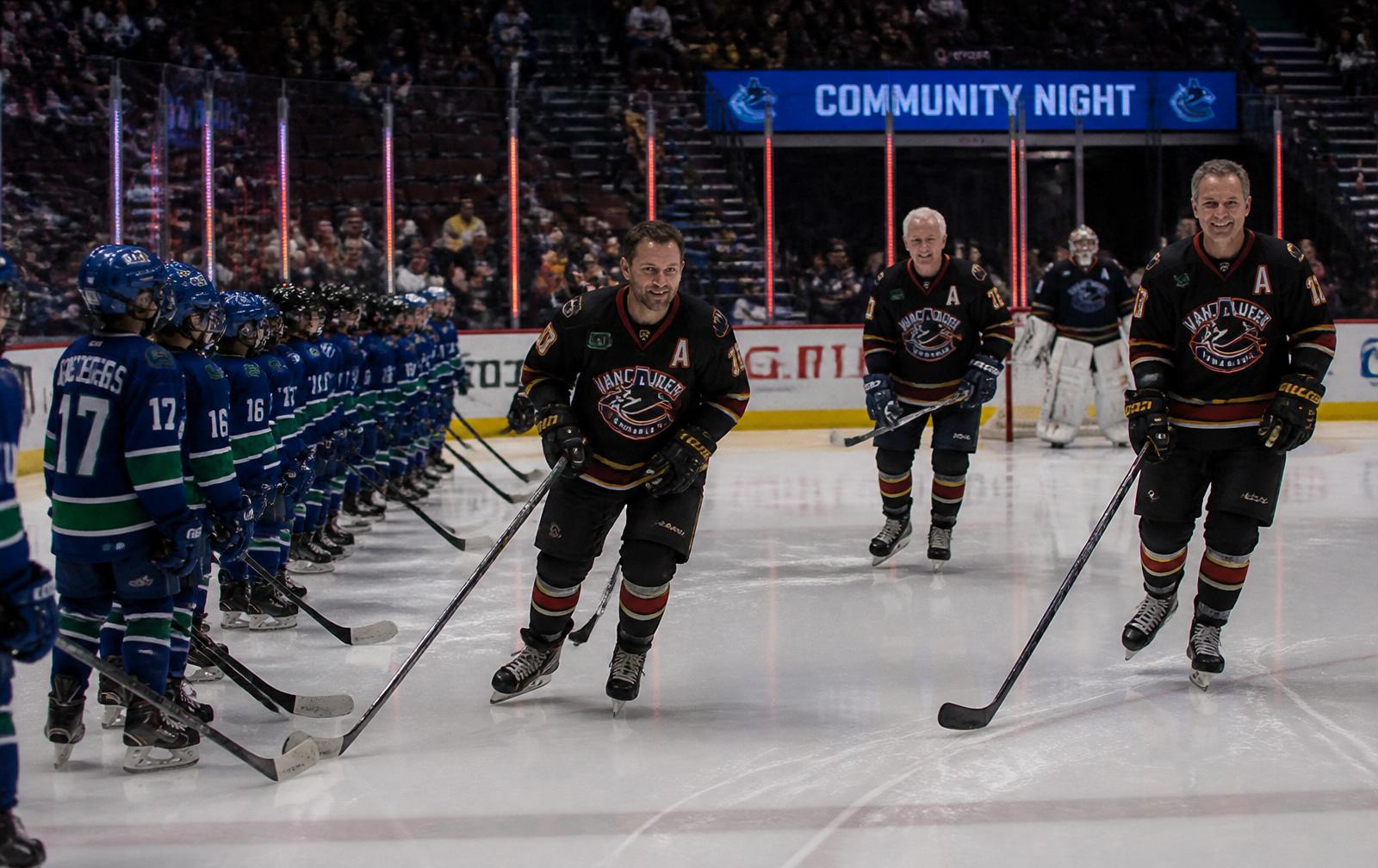 Canucks Alumni players skating out for a community game against a youth hockey team at Rogers Arena.